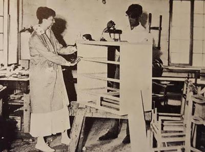 Eleanor Roosevelt with a Val-Kill Industries worker in the factory. (International News Photo)