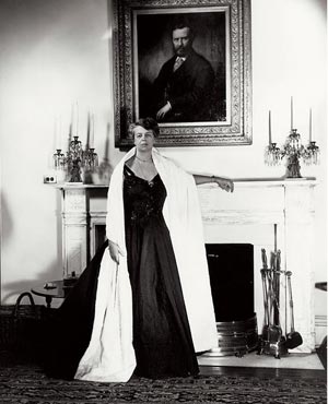Eleanor Roosevelt as First Lady, standing before a portrait of her paternal grandfather, a family role model for his social welfare work. (Corbis)