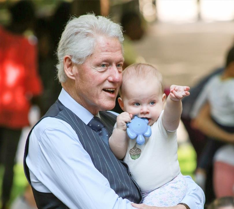 Holding his first grandchild, former President Bill Clinton's potential role as the first male presidential spouse was an element of media speculation during the 2016 presidential campaign. (INF Photo)