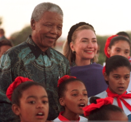 Hillary Clinton with South Africa's Nelson Mandela and young girls of that nation, 1997. (Getty)
