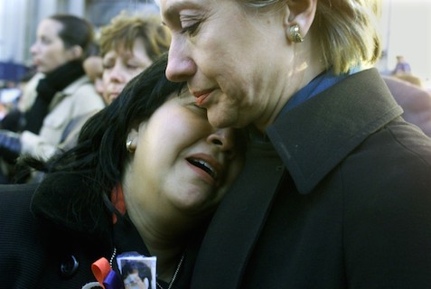 At a ground zero memorial service a month after the World Trade Center terrorist attack, Senator Clinton comforted the widow a man killed there. (Getty)