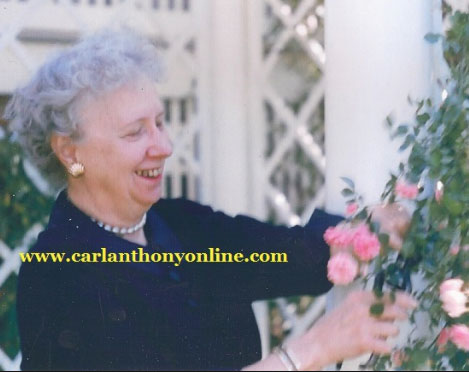 Mrs. Truman admiring some of the prized roses from her flower garden at home. (carlanthonyonline.com)